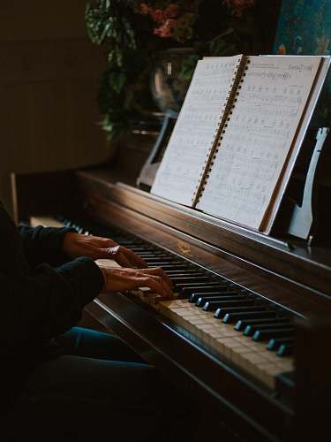 leisure activities man playing the piano in front of open music book musical instrument
